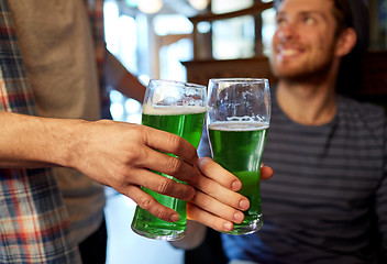 Image showing male friends drinking green beer at bar or pub