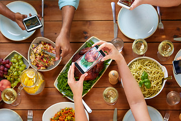 Image showing people with smartphones photographing food