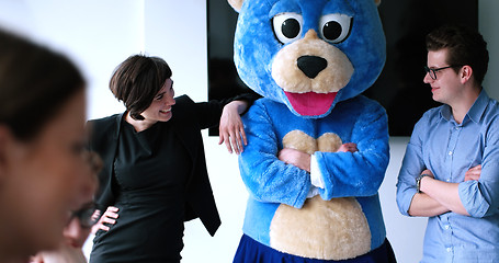 Image showing boss dresed as bear having fun with business people in trendy of