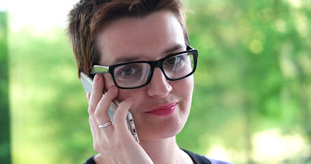 Image showing Elegant Woman Using Mobile Phone by window in office building