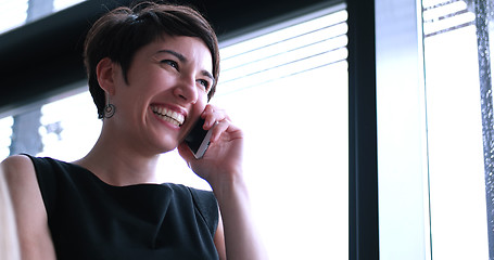 Image showing Business Girl Standing In A Modern Building Near The Window With