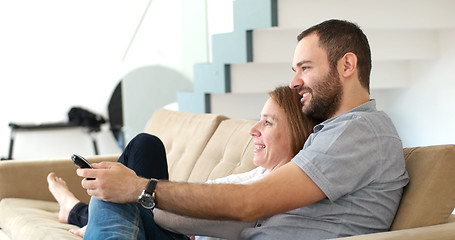 Image showing senoior couple watching tv in modern villa