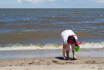 Image showing Girl Collecting Seashells