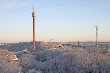 Image showing Winter morning: colourful, beautiful panorama sunrise with snow and buildings, Liseberg tower, downtown Göteborg, Sweden