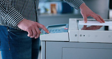 Image showing Male Assistant Using Copy Machine in modern office