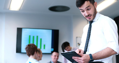 Image showing Businessman using tablet in modern office