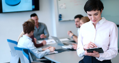 Image showing Portrait of  smiling casual businesswoman using tablet  with cow