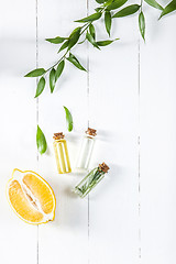 Image showing Lemon oil isolated on white wooden table