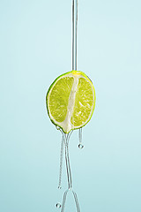 Image showing The essential oil of lemon-Drop of oil falls