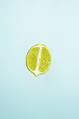 Image showing slice of lime isolated on blue background