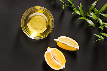 Image showing Lemon oil isolated on black table