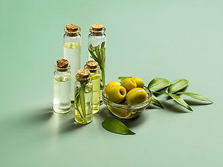 Image showing Olive oil and olive branch on the wooden table