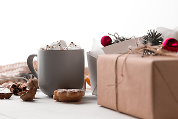 Image showing The winter composition. The gifts and cup with marshmallow