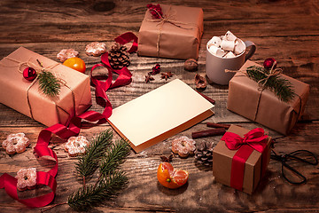 Image showing The winter composition. The gifts and cup with marshmallow