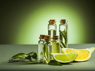 Image showing Lemon oil isolated on black table