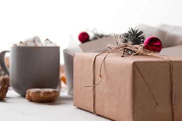 Image showing The winter composition. The gifts and cup with marshmallow