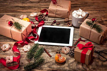 Image showing The winter composition. The gifts and cup with marshmallow