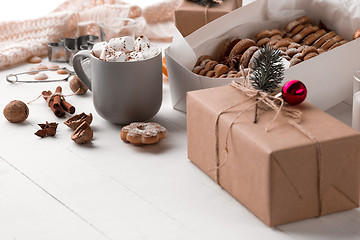 Image showing The winter composition. The gifts and cup with marshmallow