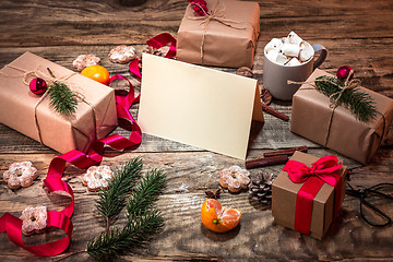 Image showing The winter composition. The gifts and cup with marshmallow