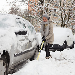 Image showing Independent woman shoveling snow in winter.