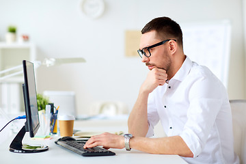 Image showing businessman typing on computer keyboard at office