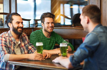 Image showing male friends drinking green beer at bar or pub