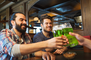 Image showing male friends drinking green beer at bar or pub