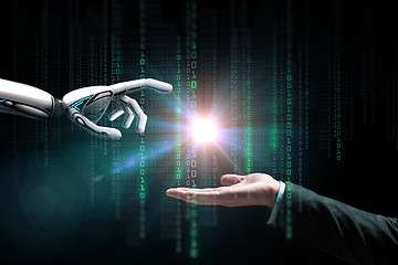 Image showing robot and human hand flash light and binary code