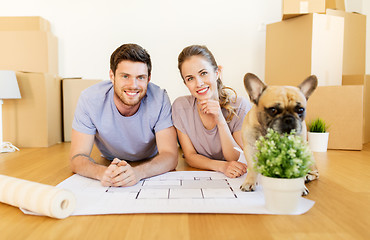 Image showing couple with boxes, blueprint and dog at new home