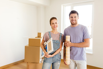 Image showing happy couple with boxes moving to new home