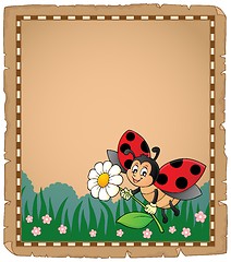 Image showing Parchment with ladybug holding flower