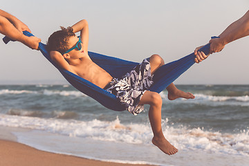 Image showing Happy little boy relaxing on the beach at the day time