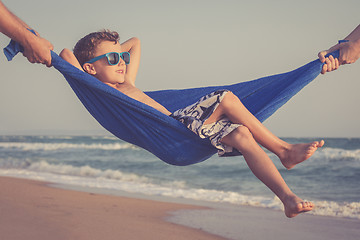 Image showing Happy little boy relaxing on the beach at the day time
