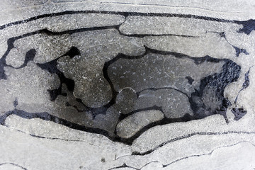 Image showing Frozen water in a puddle in winter. 