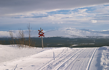 Image showing Winter panorama from Lifttoppen, ski tracks on snow marked with red cross sign, Vålådalen, Sweden