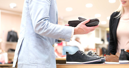 Image showing Man Chooses Shoes At Shoe Store