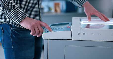 Image showing Male Assistant Using Copy Machine in modern office