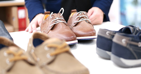 Image showing Man Chooses Shoes At Shoe Store