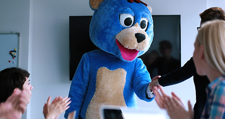 Image showing boss dresed as bear having fun with business people in trendy of