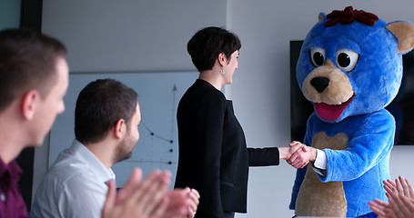 Image showing boss dresed as bear having fun with business people in trendy of