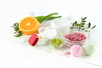 Image showing Spa concept with salt, mint, lotion, towel on white background