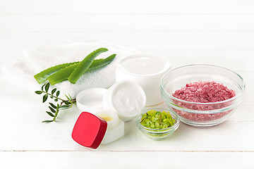 Image showing Spa concept with salt, mint, lotion, towel on white background