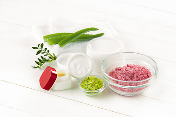 Image showing Spa concept with salt, mint, lotion, towel on white background