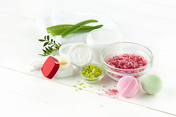 Image showing Spa concept with salt, mint, lotion, towel on white background