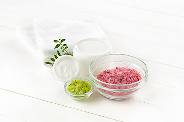 Image showing Spa concept with salt, mint, lotion, towel on white background