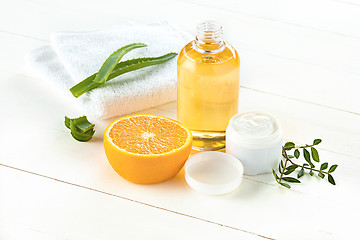 Image showing Spa concept with salt, mint, lotion, towel on white background