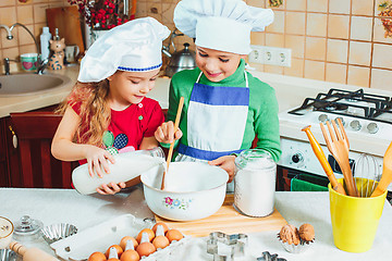 Image showing happy family funny kids are preparing the dough, bake cookies in the kitchen