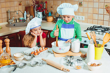 Image showing happy family funny kids are preparing the dough, bake cookies in the kitchen