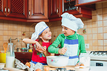 Image showing happy family funny kids are preparing the dough, bake cookies in the kitchen