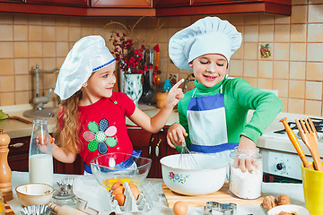 Image showing happy family funny kids are preparing the dough, bake cookies in the kitchen